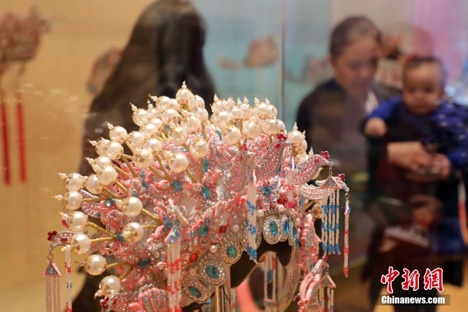 观众在欣赏精美凤冠帽饰作品. 中新社记者 洪少葵 摄