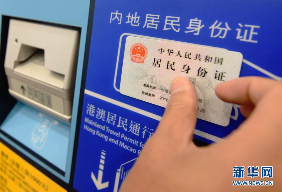 在香港西九龙站,一名男子在自助购票机上刷内地居民身份证购买车票